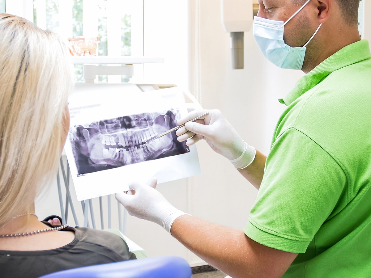 Image of a dentist explaining an x-ray to a patient