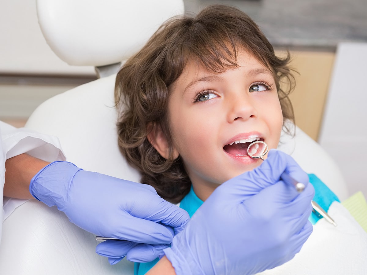 Image of a kid getting their teeth examined