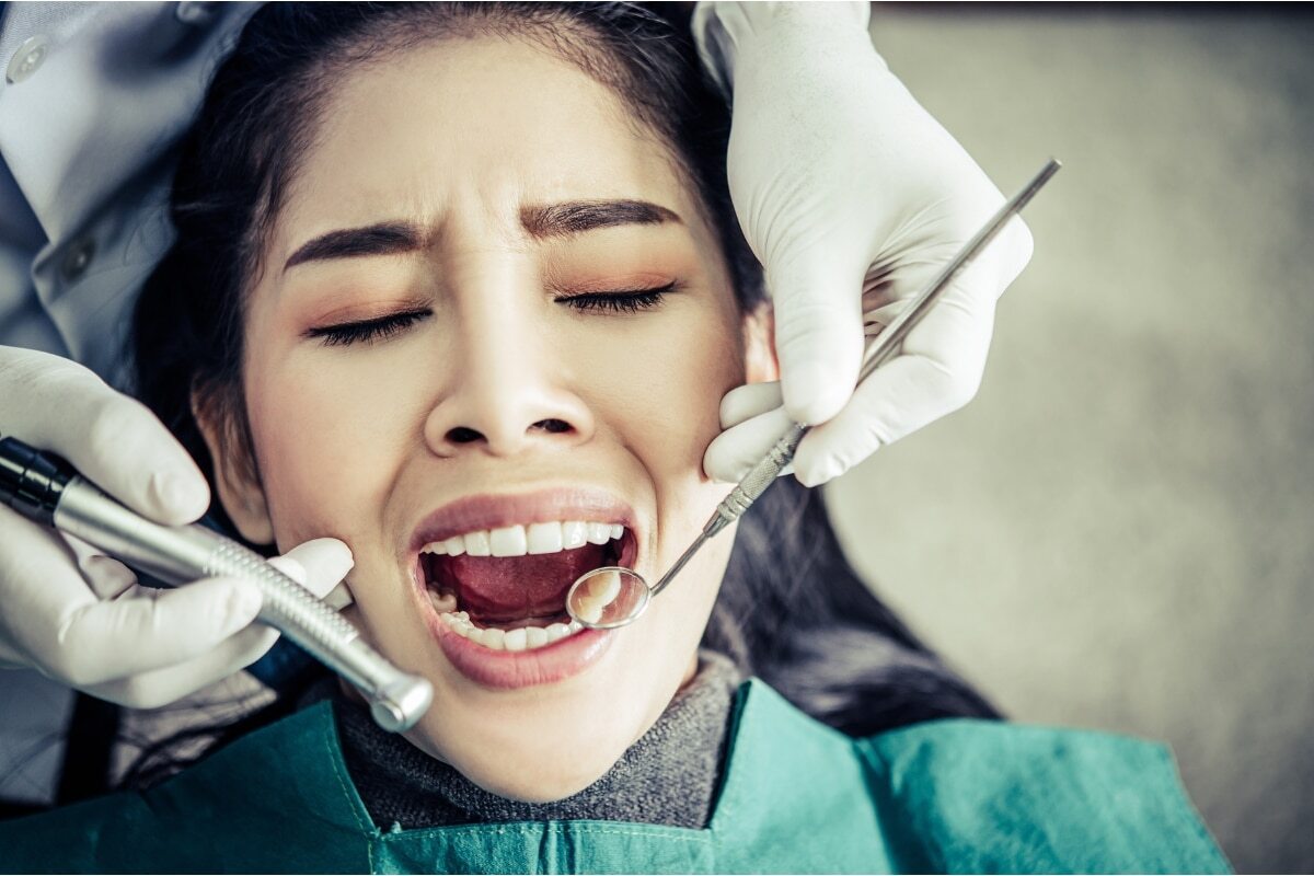 Patient receiving dental examination and treatment at dental office in Denver, Colorado.